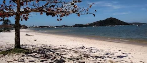 On the beach, white sand, beach umbrellas, beach yoga