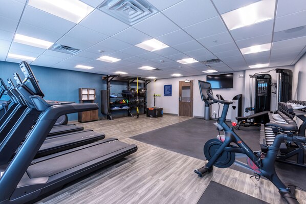 A gym with treadmills, a stationary bike, and weight machines. - Hampton Inn & Suites Bakersfield Central (Bakersfield)