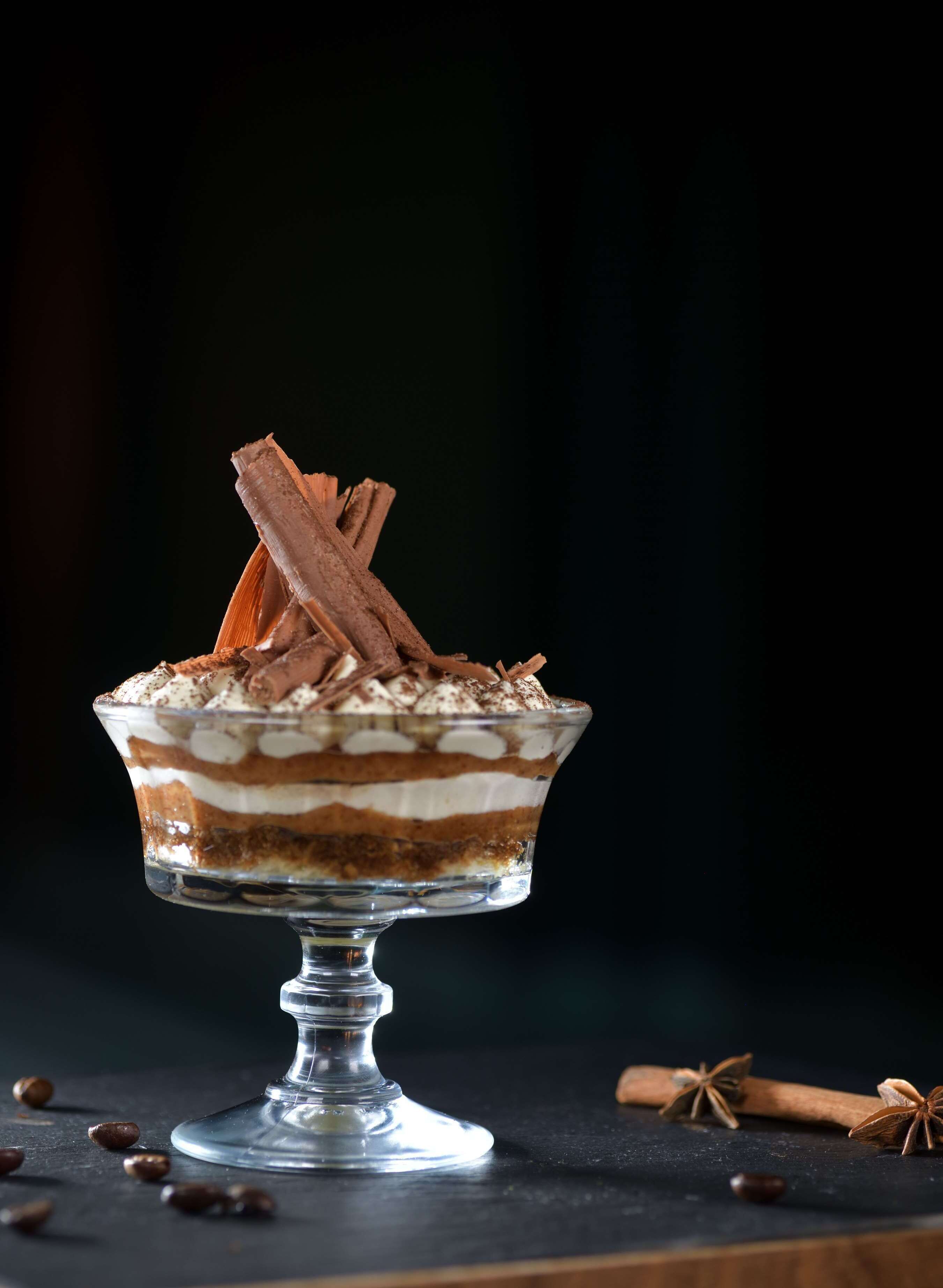 A dessert in a glass bowl on a stand.