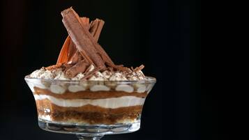 A dessert in a glass bowl on a stand.