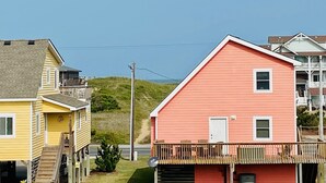 A coastal residential area with houses featuring balconies and a clear view of the ocean. - "Claire Skies" 75 yards to Beach access! (Nags Head)