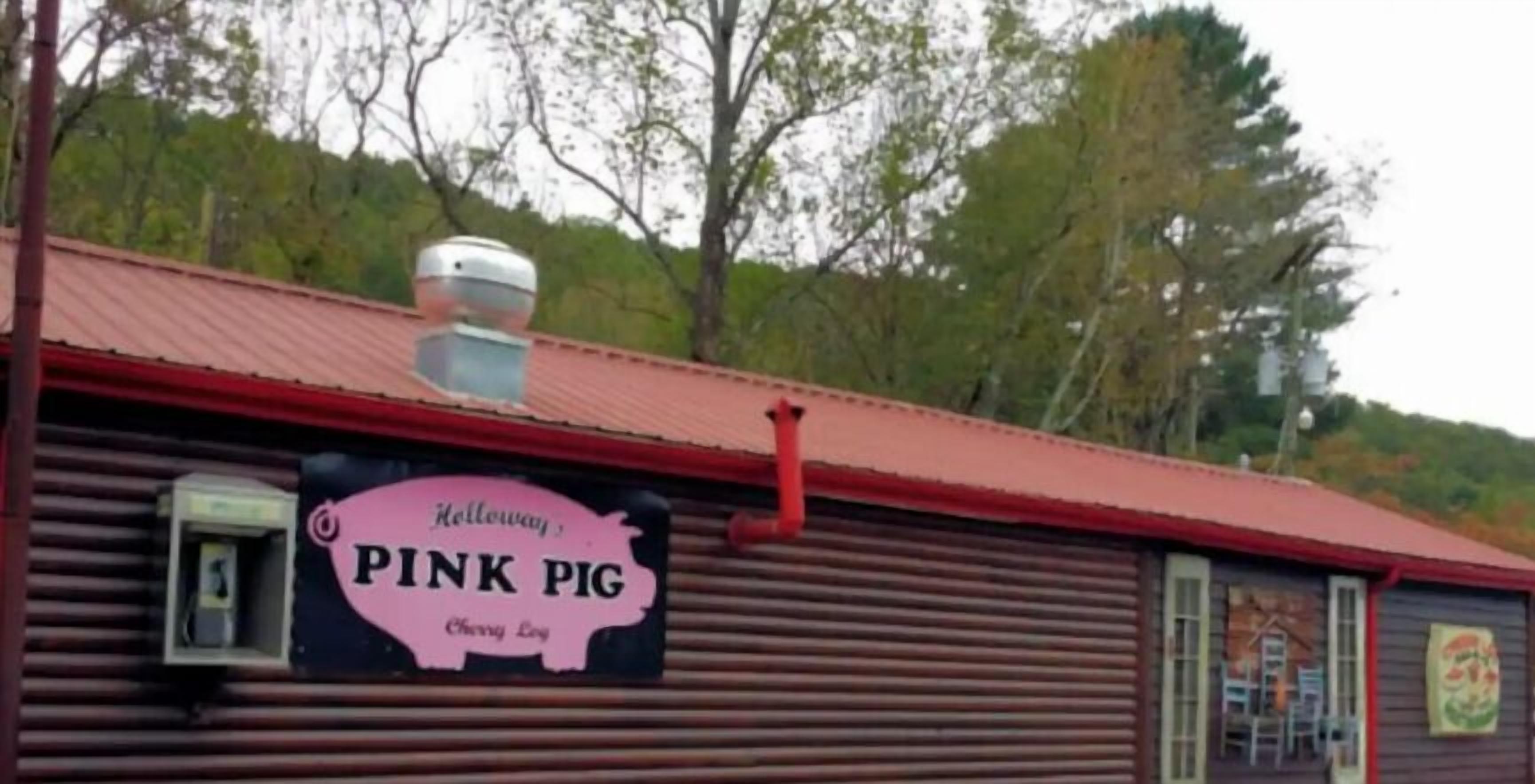 A building with a sign reading "Holloway's PINK PIG" and a logo of a pig.
