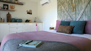 A bedroom with a bed, bedside table, and a wardrobe with a rustic design. - Wake with the Kangaroos: Sunrise Cabin Escape in Mudgee (Frog Rock)
