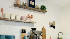 A modern kitchen with a coffee machine, tea kettle, and a dishwasher. - Wake with the Kangaroos: Sunrise Cabin Escape in Mudgee (Frog Rock)