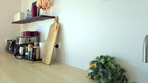 A kitchen with a wooden countertop, a cutting board, a coffee maker, and a knife rack. - Golden Hour Views: Sunset Cabin with Outdoor Bath (Frog Rock)