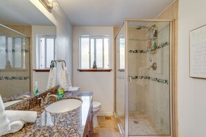 A bathroom with a granite countertop sink, a glass-enclosed shower, and a large mirror. - 9 Mi to Dtwn Denver: Aurora Vacation Rental (Aurora)
