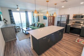 A modern kitchen with a central island, stainless steel appliances, and pendant lighting. - 1 BR Condo Downtown Sarasota - Close to beaches - Enjoy Sarasota (Sarasota)