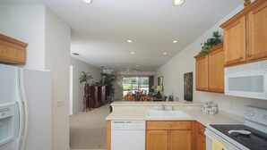 A kitchen with wooden cabinets, a dishwasher, a stove, and a microwave.