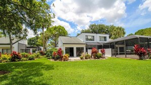 A modern house with a well-maintained lawn and garden.