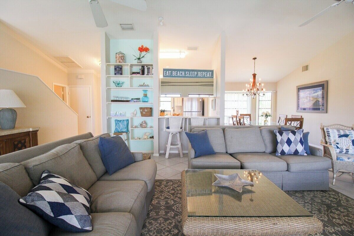 A living room with a sofa set, a coffee table, and a bookshelf.