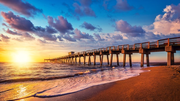 A pier extending into the ocean with a sunset in the background. - 3 BR Pool Home In Nokomis - Close To Beaches - Tropical Escape (Nokomis)