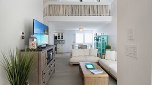 A spacious living area with a television, sofa, and coffee table. - Cozy 2BR condo on Lido Key, steps from the beach - Lido Del Mare (Sarasota)