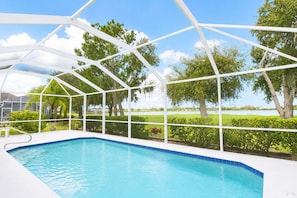 A swimming pool with a white roof structure, surrounded by greenery and trees. - Stunning 3BR lakefront - Pool home in Palmetto - Cranes Galore (Palmetto)