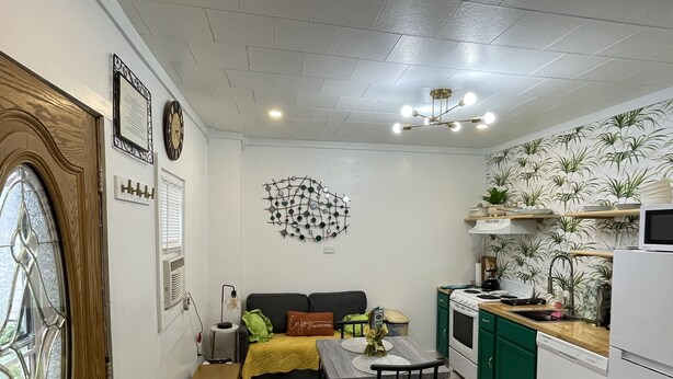 A compact living space with a kitchenette, a dining area, and a sofa. - A  Cozy studio unit in northern Wisconsin (Antigo)