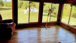 A room with large windows, a wooden ceiling, and a fan. - Peaceful, spacious 4 bedroom house in the country - Gazebo/Pond
 (Keosauqua)