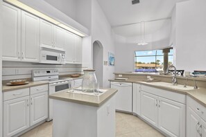Fridge, microwave, oven, stovetop - Villa Andrea - Almost 2,700 sqft heated pool home on triple lot w/sailboat access! - SWFL Rentals (Cape Coral)