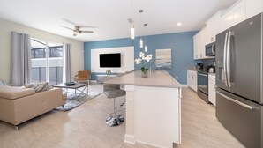 A modern kitchen with a central island, stainless steel appliances, and a large window. - LN4816 Storey Lake Home 4Beds 3Baths Private Pool and Free Waterpark (Kissimmee)