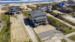 A coastal residential area with houses, a beach, and a clear view of the ocean. - Calypso's Dream (North) | Oceanfront | Hot Tub and Dog Friendly (Nags Head)