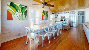 A spacious kitchen with wooden cabinets, a refrigerator, and a microwave.