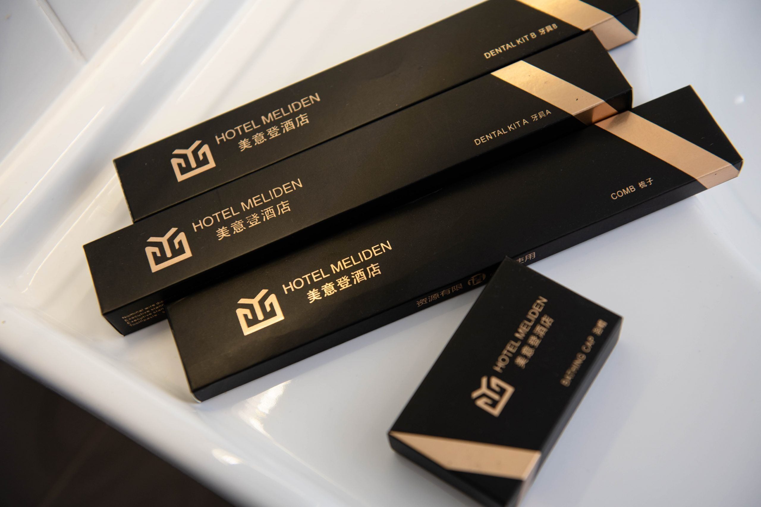 Black boxes with gold text and logos, likely containing hotel amenities or information.