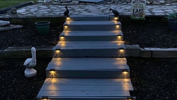 A wooden pathway leading to a dock with a sign reading "Welcome to our Lake House." - Lakeside Paradise with Priceless Views (Toledo)