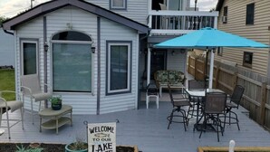 A deck with outdoor furniture, a welcome sign, and a view of a lake. - Lakeside Paradise with Priceless Views (Toledo)