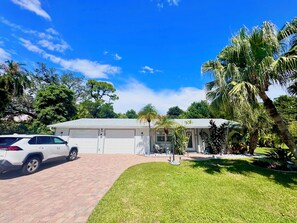 A residential property with a garage, a driveway, and a well-maintained lawn.