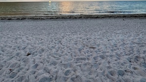 A beach with a sandy shore and a view of the ocean under a partly cloudy sky. - Key Biscayne Gem — Steps to Beach, Pool Views, King Bed, Parking (Key Biscayne)