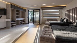 Une chambre moderne dotée d’un grand lit, de rangements intégrés et d’une porte-fenêtre coulissante donnant sur un balcon.