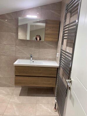 Een haardroger, handdoeken, zeep, toiletpapier