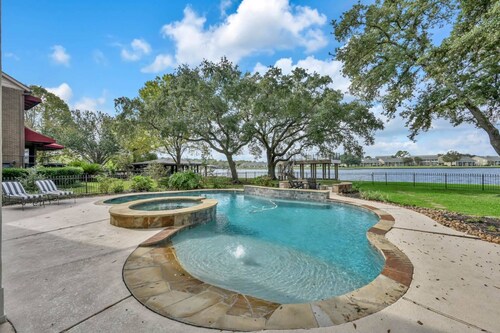 Lux Waterfront Home | 2 Primary Suites, 4 BR, Boat Dock & Views | Heated Pool & Spa
