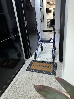 Accessible accommodations lead to a welcoming room with a black door.