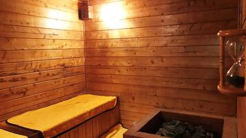 A sauna room with wooden walls, a bench, and a brick sauna floor.