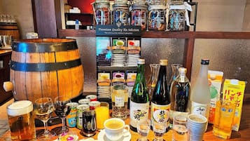 Enjoy a selection of beverages and snacks at our bar, featuring a variety of drinks and condiments.