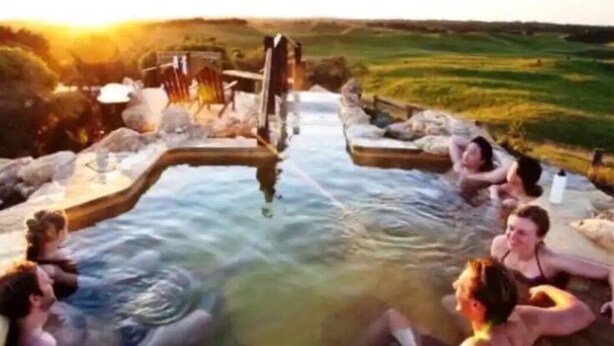 A hot tub area with a view of a sunset over a grassy landscape. - Tri level house with 5 bdrms, game room, balcony with valley view & deck. (Rye)