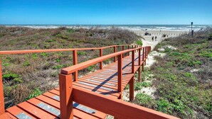 A wooden boardwalk leading to a beach with a clear view of the ocean and sandy dunes. - Gulf Views + Private Balcony + 2 Pools + Pickleball | Beachfront | Beach Please! (Port Aransas)