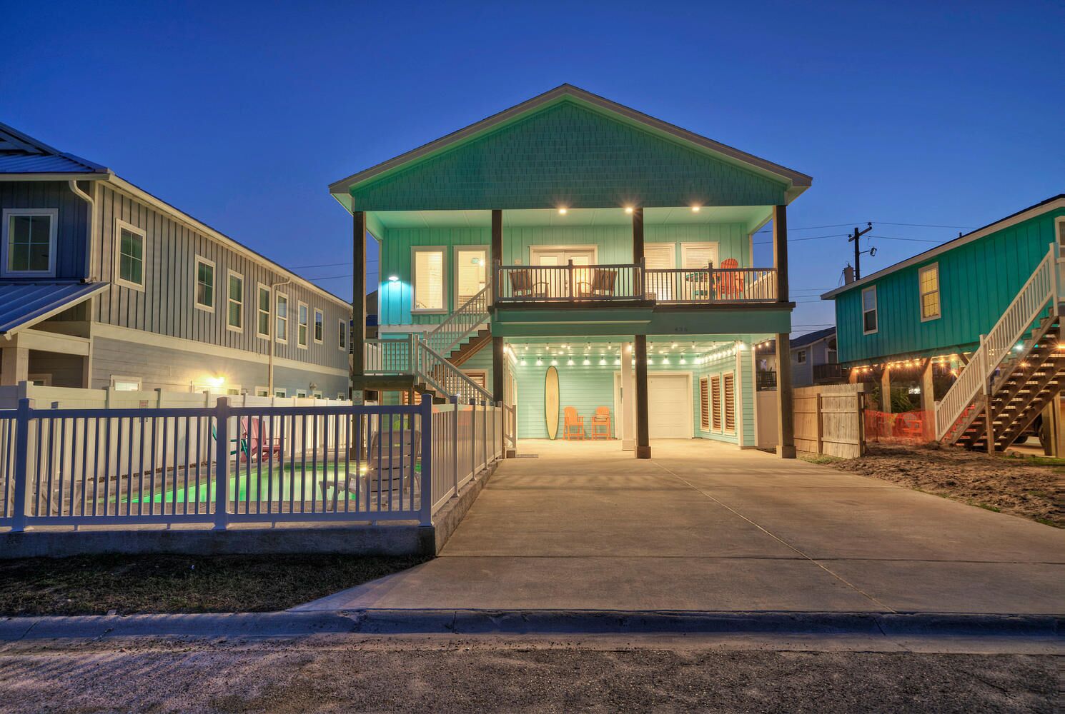 Une maison à deux étages avec un balcon, un porche à l’avant et une allée.