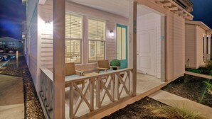 A house with a covered porch, a door with a number, and a small garden area. - Pool | 1 Block to Alister + Old Town + Eateries | Bluegrass Breeze by AvantStay (Port Aransas)