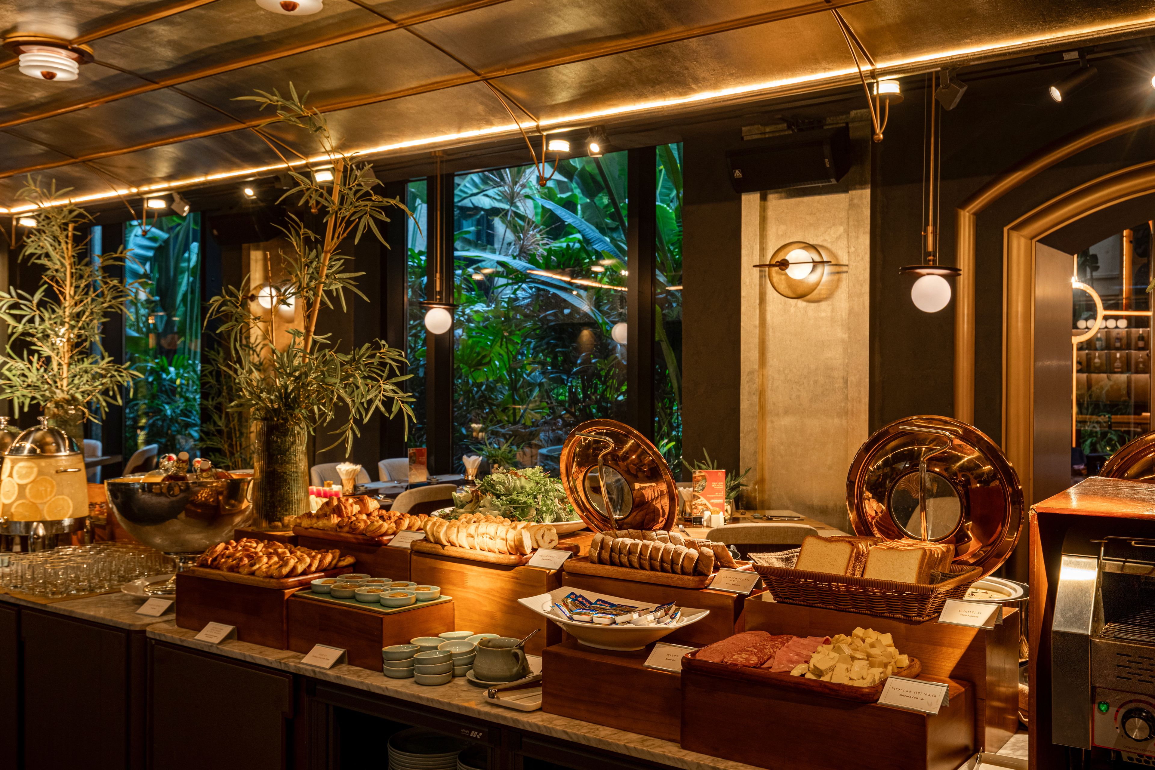A buffet with various food items and a coffee station.