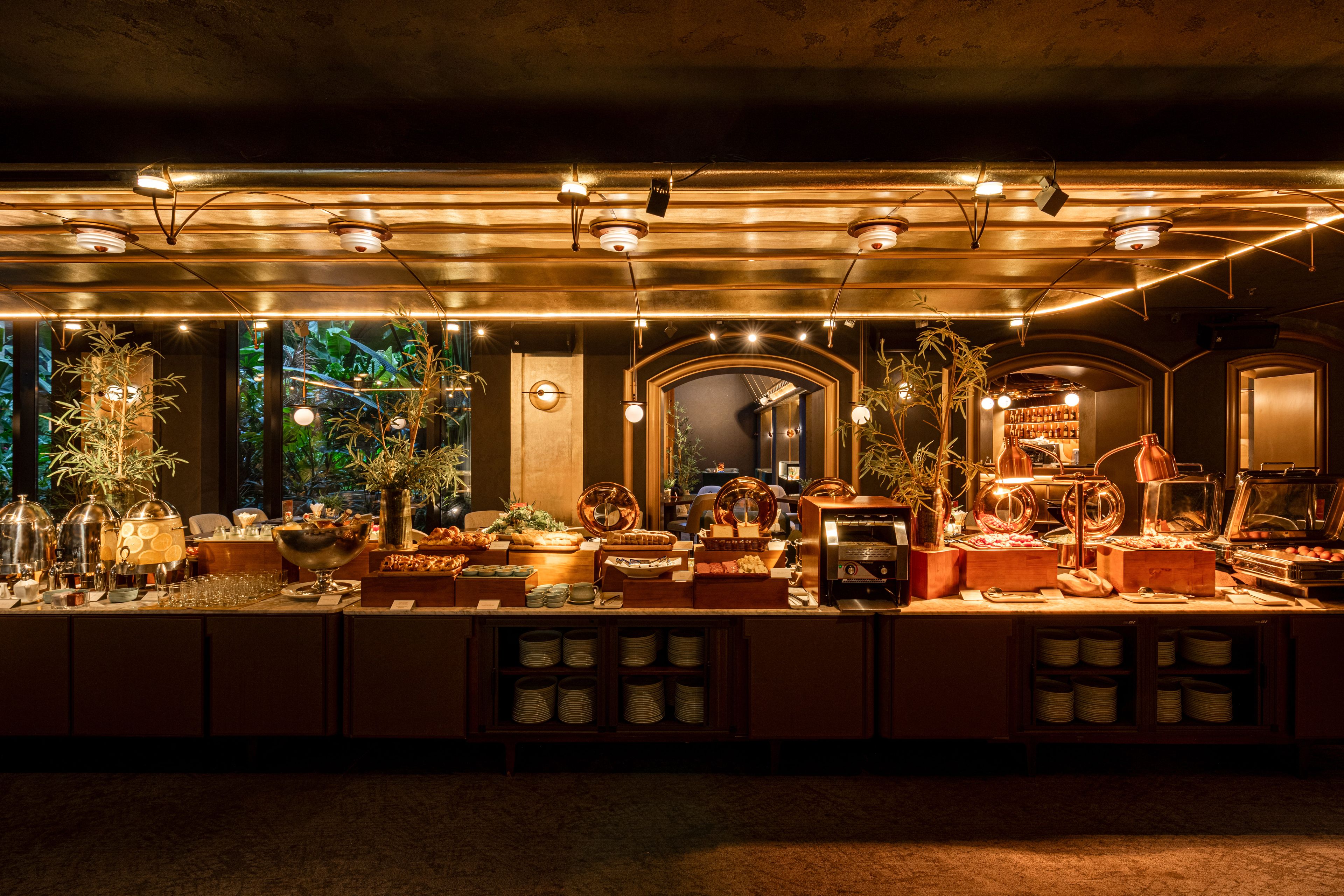 A buffet setup with various food items and a coffee station.