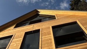 A wooden building with large windows and a sloped roof. - Bakhmaro (Bakhmaro)