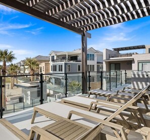 Relax in style with comfortable lounge chairs and a scenic view of the surrounding neighborhood.