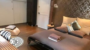 A bedroom with a bed, pillows, a bedside table, and a wardrobe. - Le Grand Stanislas, 130 m2 Hypercentre 2/6 Pers (Nancy)
