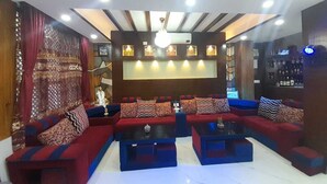 A modern living room with a sectional sofa, a coffee table, and a bar area. - York  Air Home (Kathmandu)