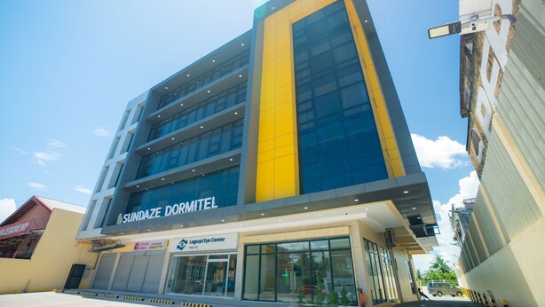 A multi-story building with the signage 'SUNDAZE DORMITEL'. - Sundaze Dormitel (Naga)