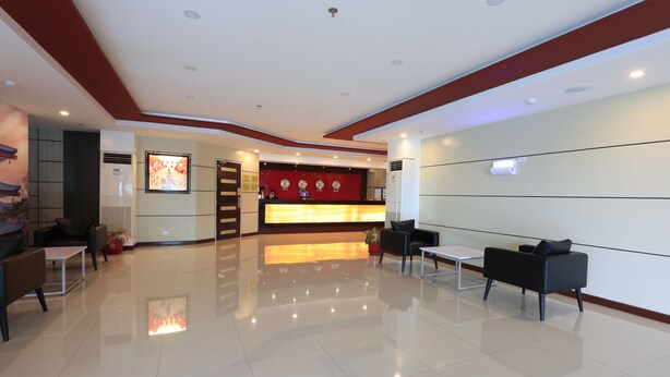 A modern hotel lobby with a reception desk, seating area, and a clean, polished floor. - Hotel Sogo Davao (Davao)