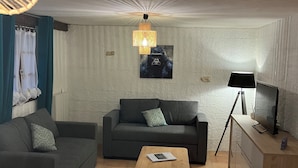 Een moderne woonkamer met een bank, een salontafel en een tv-meubel.