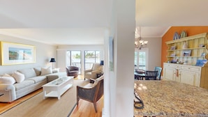 A living room with a sofa, coffee table, and chairs, a kitchen with a granite countertop and cabinets, and a dining area with a table and chairs. - Lakeside Updated Villa: Pool and Beach Access (Pawleys Island)
