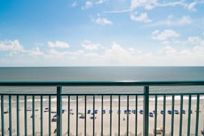 Enjoy the ocean views from this beachside spot, where umbrellas line the shore and gentle waves roll in.