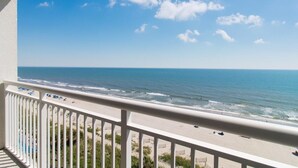 A balcony with a view of the beach and ocean. - Oceanfront Haven 1 Br King Deluxe Condo 7th Floor (Myrtle Beach)